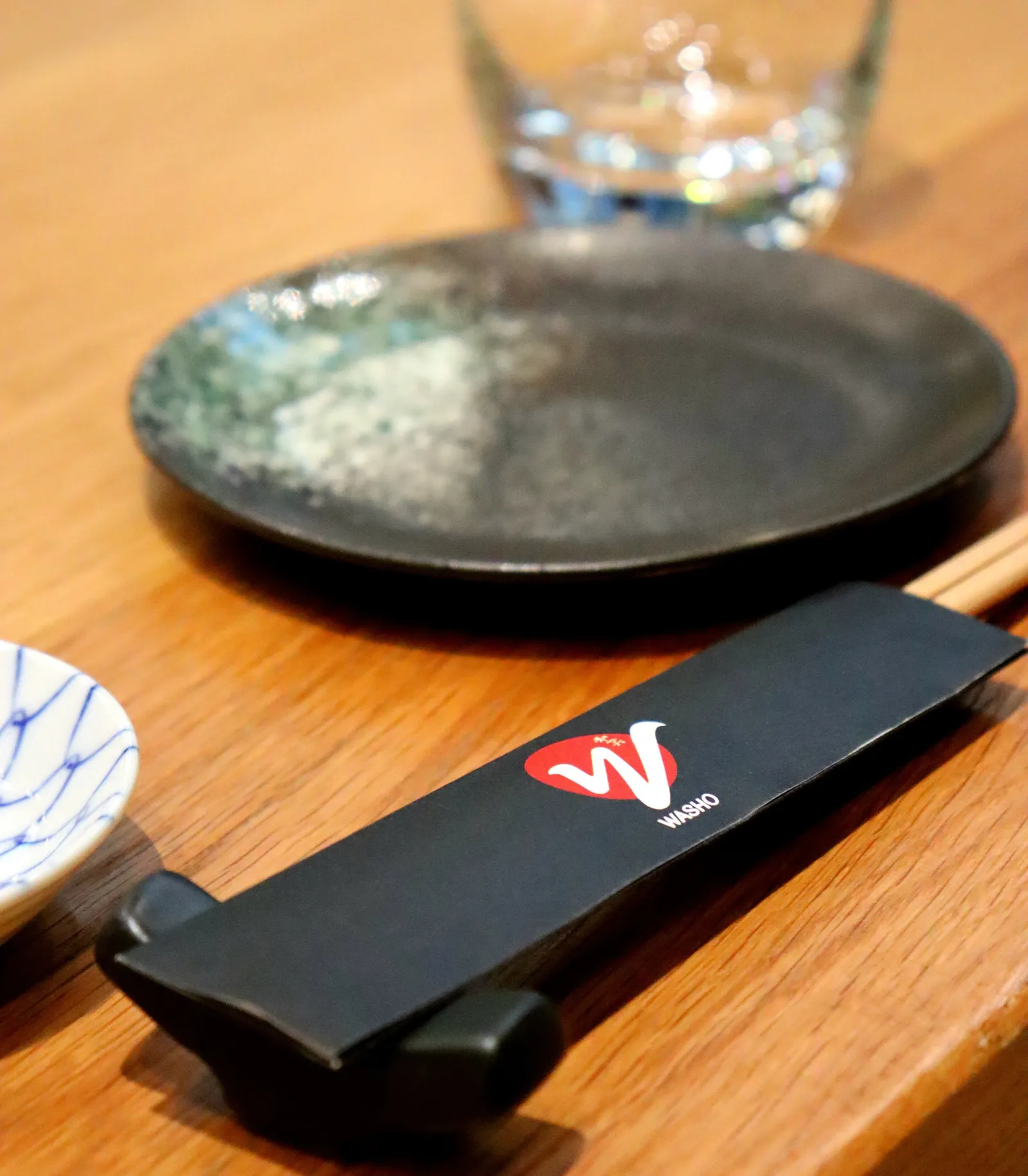 Table setting with Washo chopsticks on a wooden counter